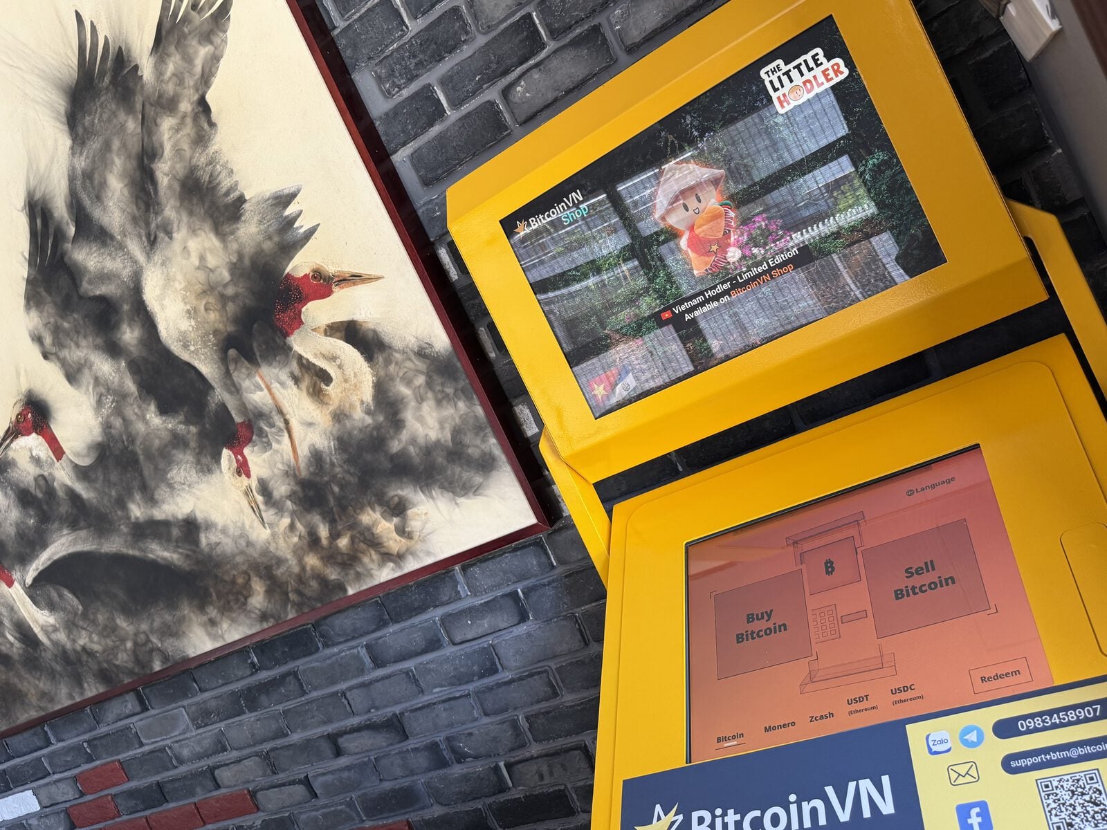 BitcoinVN BTM next to artwork inside Westwood Da Nang